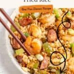 Bowl of Cajun fried rice with shrimp, sausage, vegetables, chopsticks, and text: Cajun Fried Rice recipe.