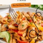 Plate of chicken fajita pasta with vegetables, lime garnish, fork; text: Chicken Fajita Pasta, One Pot Dinner Recipe.