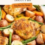 Sheet pan with cooked chicken thighs, potatoes, green beans, carrots, and herbs. Overlay: “Chicken Thighs & Veggies Sheet Pan.”.