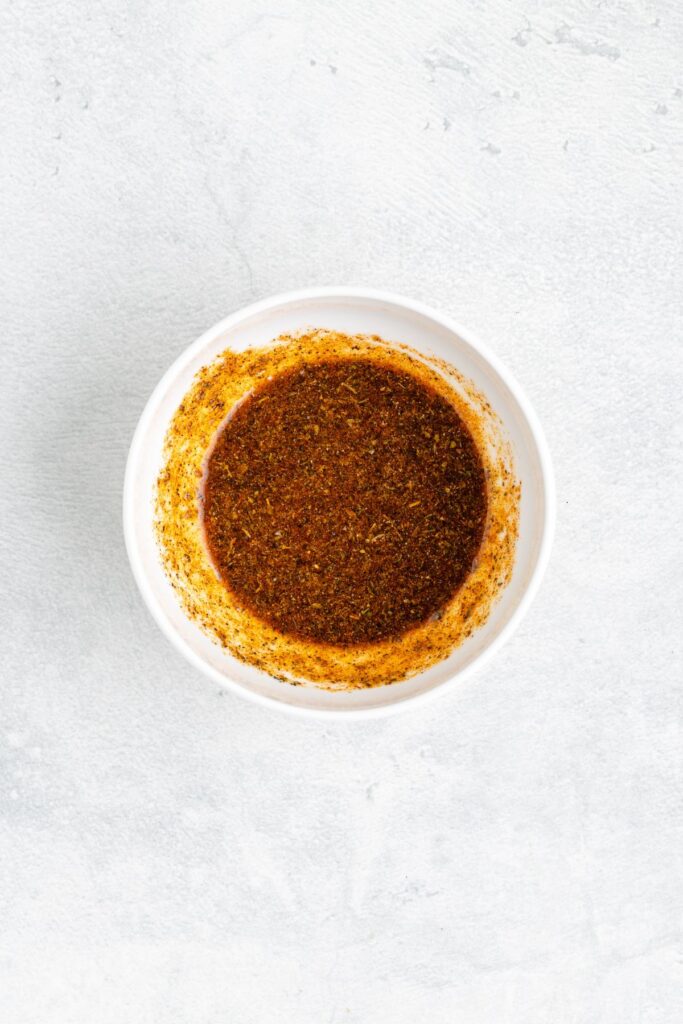 Small white bowl filled with seasoning rub.