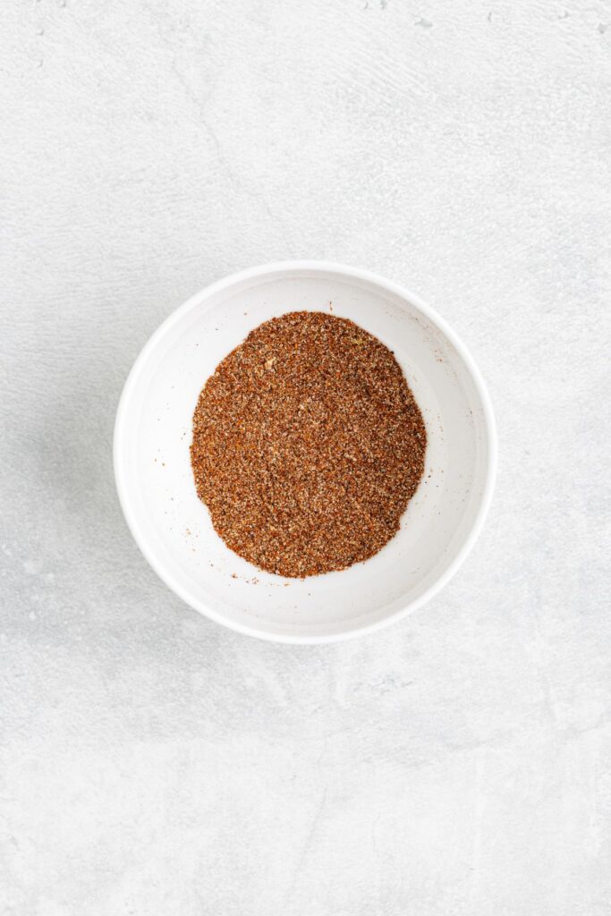 A white bowl filled with a fajita seasoning mix.