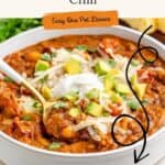 Bowl of turkey pumpkin chili with avocado, cheese, sour cream, and a spoon. Text says easy one-pot dinner, recipe link.