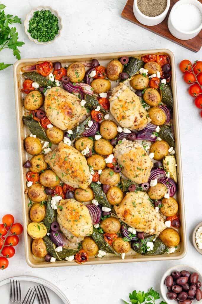 Mediterranean Sheet Pan Chicken, potatoes, zucchini, onions, tomatoes, olives, feta, and fresh herbs.
