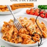 Penne pasta with chicken in tomato sauce, topped with cheese on a plate and a fork.