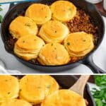 Cast iron skillet with ground beef and golden biscuits, one biscuit being lifted out.