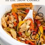 Slow cooker with chicken fajitas—sliced chicken, peppers, onions—stirred by white spoon. Recipe text above.