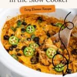 Slow cooker with enchilada casserole, topped with jalapeƱos, olives, melted cheese; text: Enchilada Casserole In the Slow Cooker.